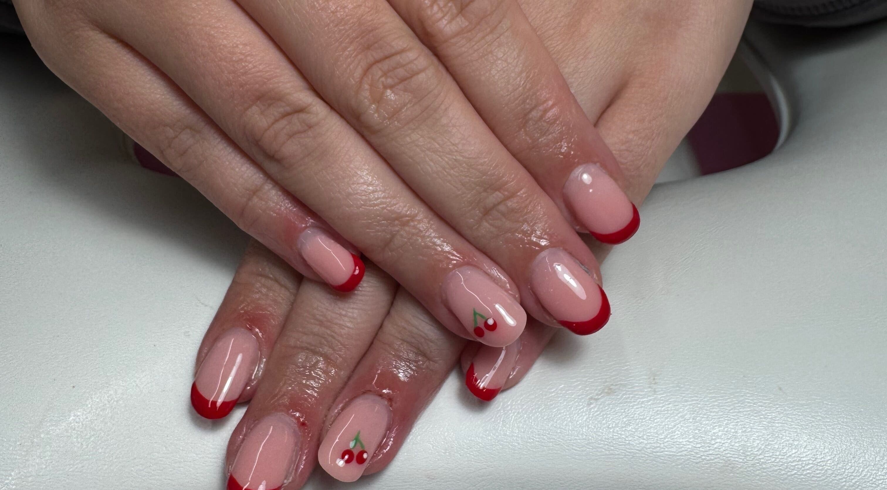Stylish cherry nail art at JL Tanning and Nails, Exmouth, England, GB. Perfect manicure with red accents.