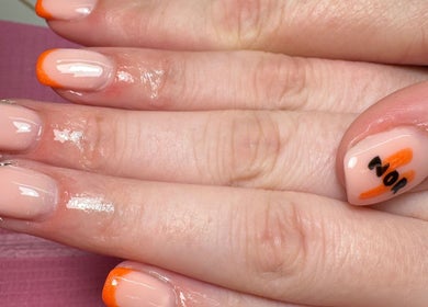 Stylish nail art with orange and black designs at JL Tanning and Nails in Exmouth, England, GB.