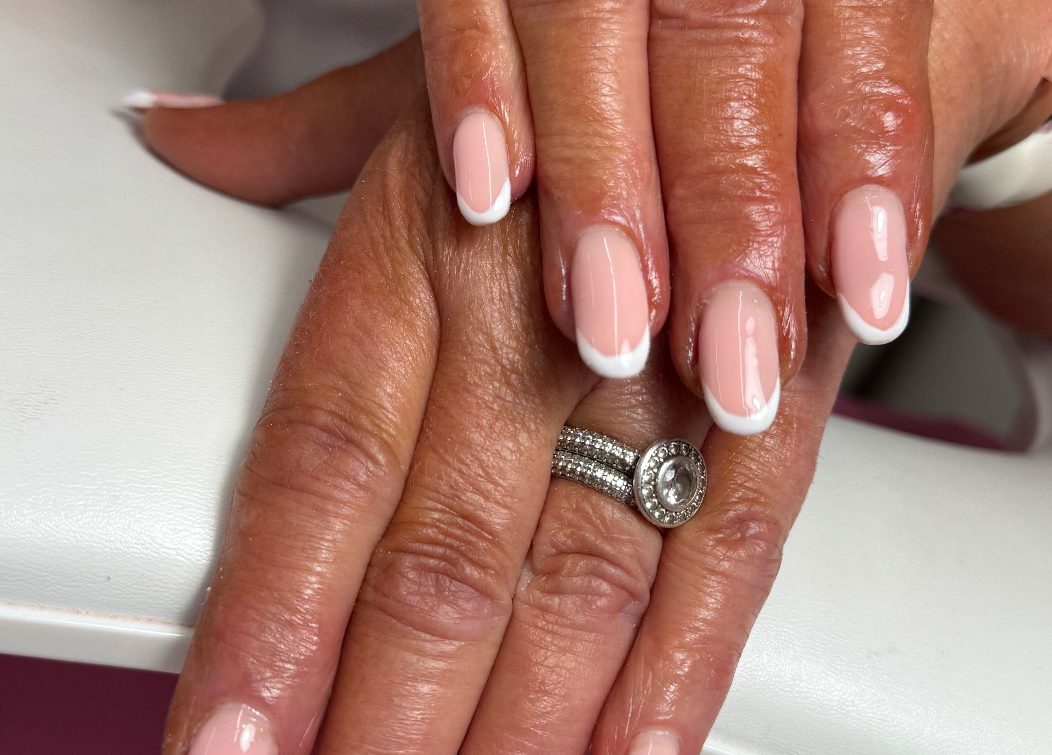 Perfectly manicured French nails at JL Tanning and Nails, Exmouth, England, GB, showcasing elegance.