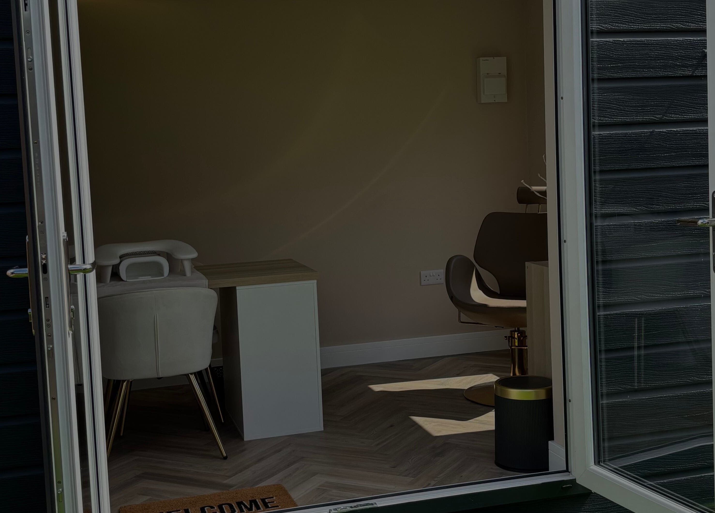 Entrance to By Jessie's cozy treatment room in Rumney, Wales, GB, showcasing chic interior design.