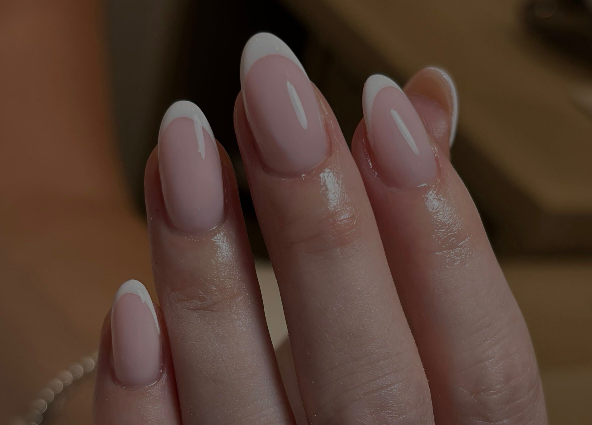 Elegant French manicure at By Jessie, Rumney, Wales, GB showcasing glossy, perfectly shaped nails.
