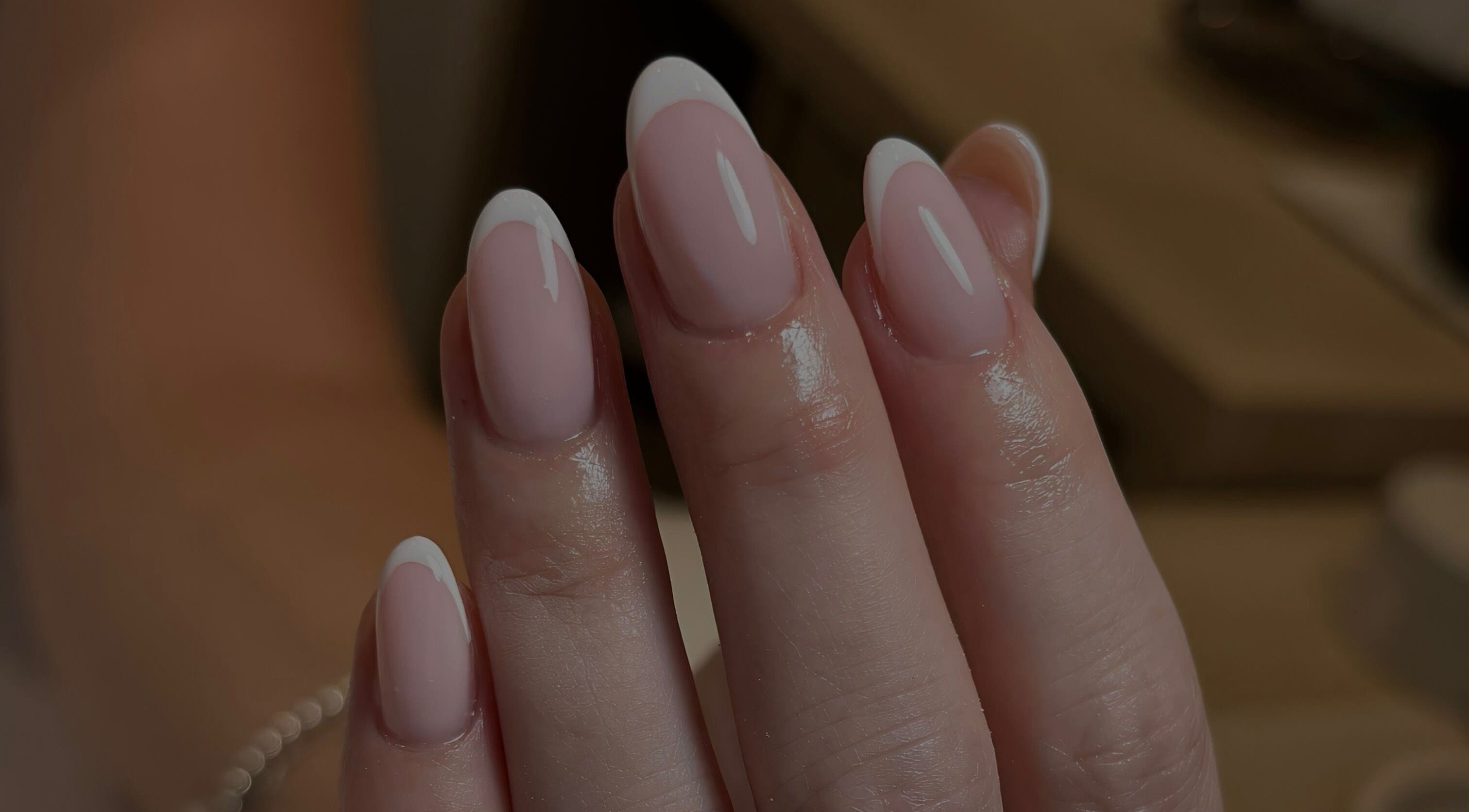 Elegant French manicure at By Jessie, Rumney, Wales, GB showcasing glossy, perfectly shaped nails.
