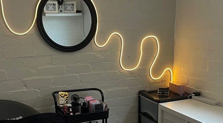 Cozy corner at DEFYNED BEAUTY, Wrexham, Cymru, GB, with neon lighting and a beauty station setup.
