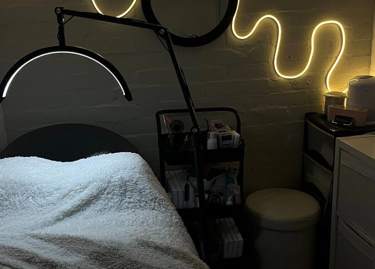 Cozy treatment room at DEFYNED BEAUTY in Wrexham, Cymru, GB with ambient lighting and a comfortable bed.