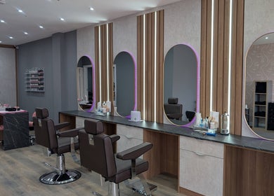 Elegant salon interior at Glowfinity - Woodley, featuring stylish mirrors and chairs in Woodley, England, GB.