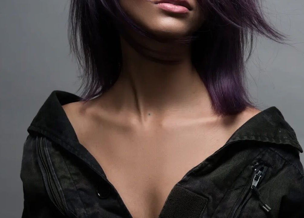 Purple-haired model at Gatsby Studio Salon and Spa in Toronto, Ontario, CA showcasing elegant style.