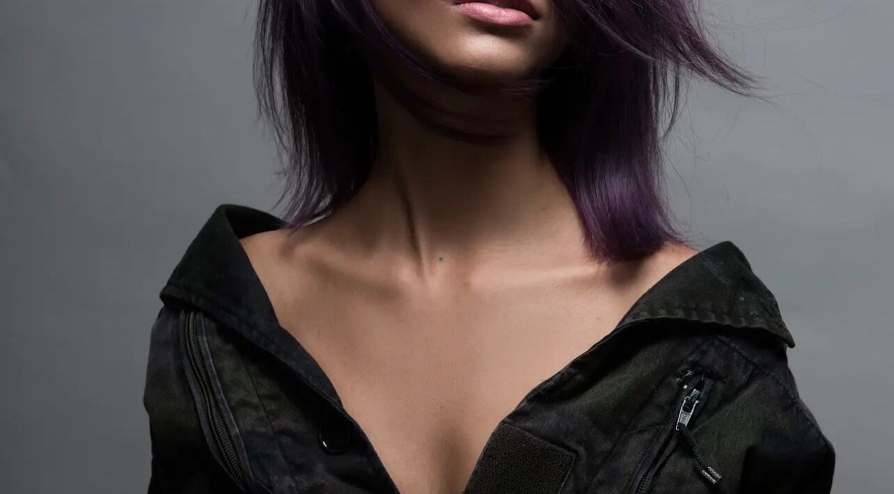 Purple-haired model at Gatsby Studio Salon and Spa in Toronto, Ontario, CA showcasing elegant style.