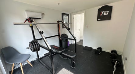 Well-equipped gym at Deaconsbank Physiotherapy, Glasgow, Scotland, GB. Features weights and exercise chair.