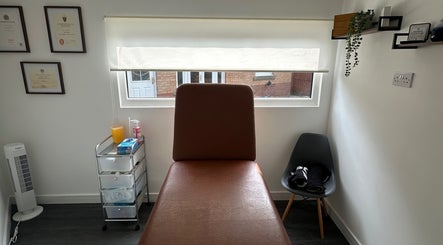 Cozy therapy room at Deaconsbank Physiotherapy in Glasgow, Scotland, GB featuring a treatment bed and equipment.