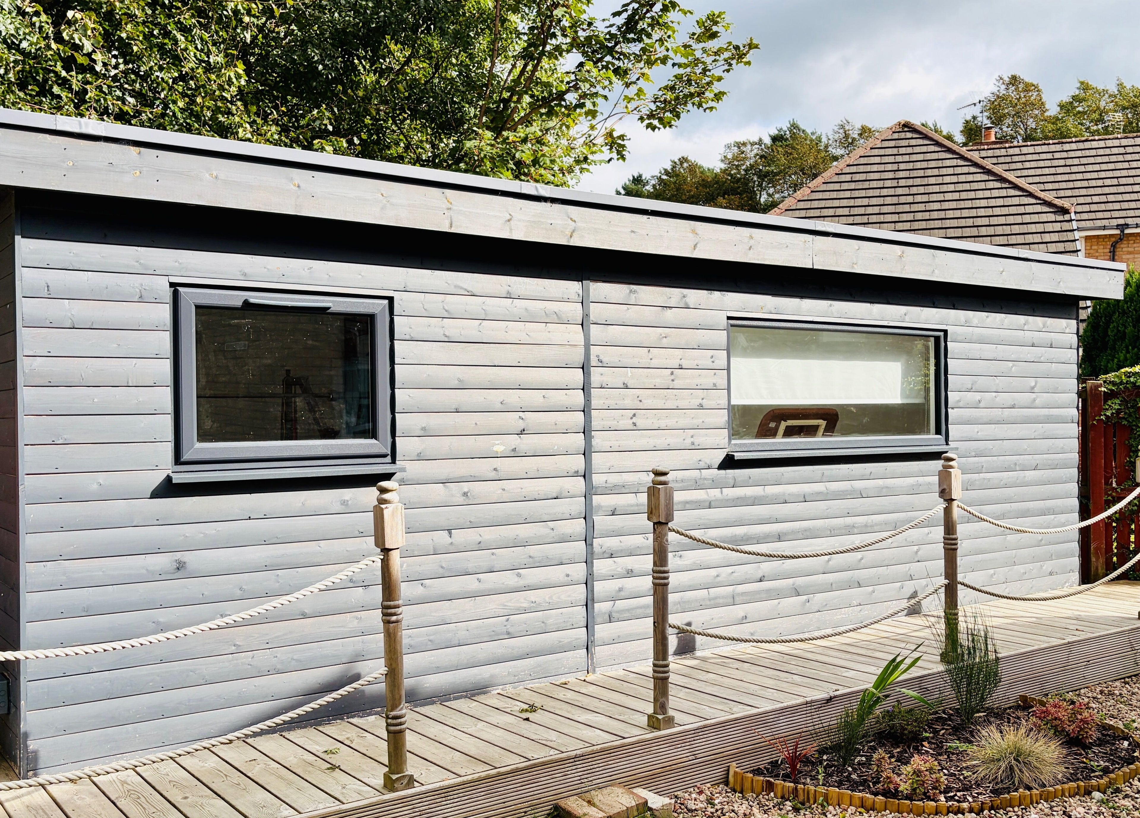 Exterior of Deaconsbank Physiotherapy studio in Glasgow, Scotland, GB, surrounded by lush greenery.
