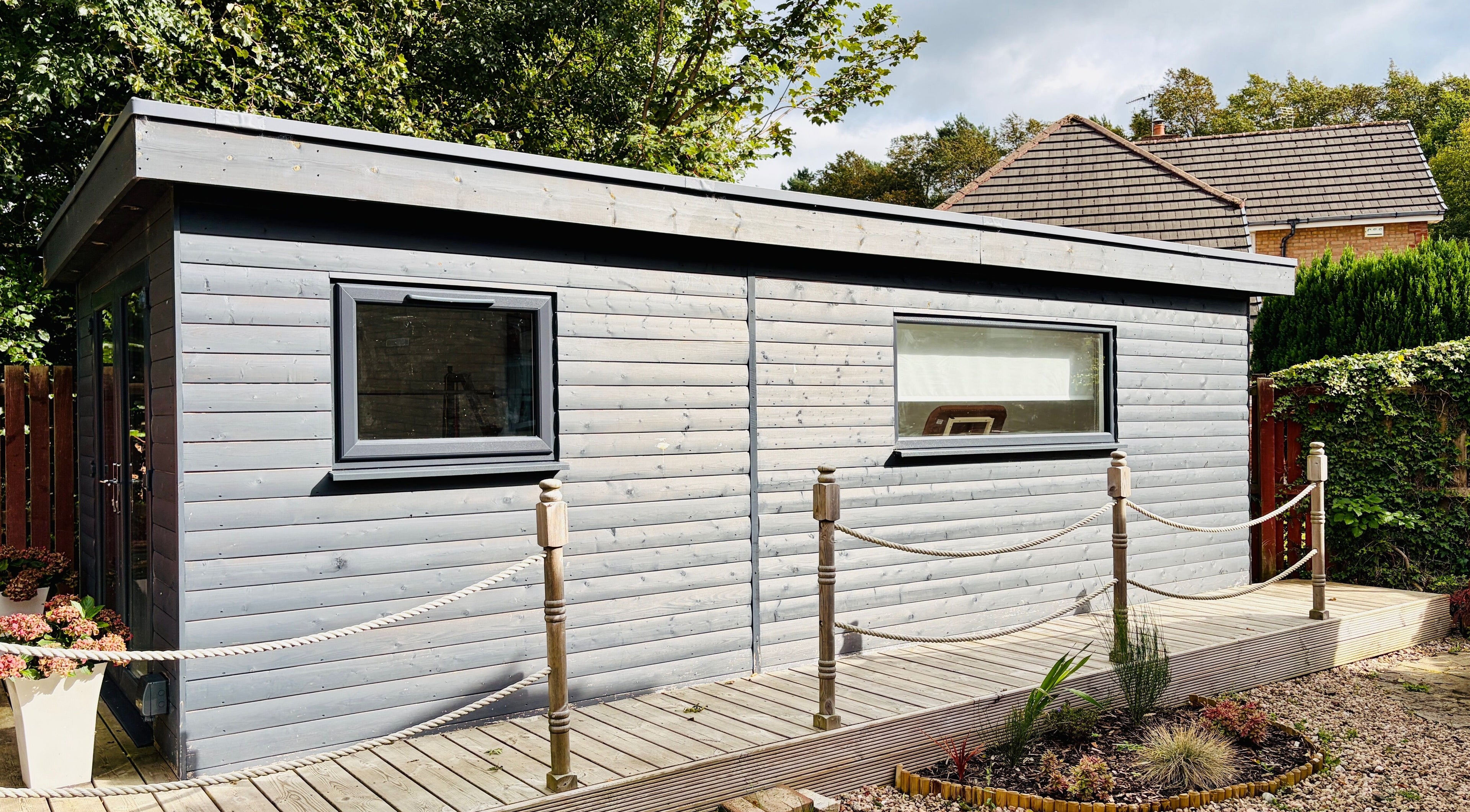 Exterior of Deaconsbank Physiotherapy studio in Glasgow, Scotland, GB, surrounded by lush greenery.