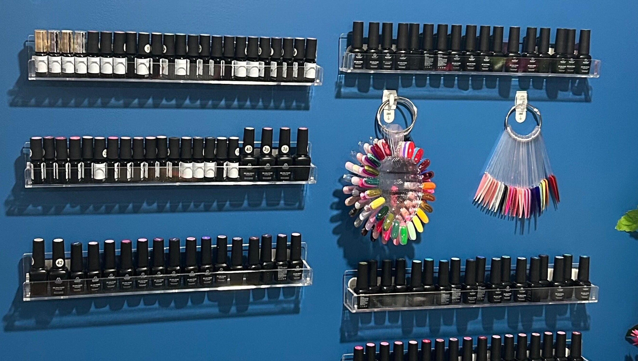 Nailss.ByKeira in Ottawa showcases a vibrant polish display with color samples.