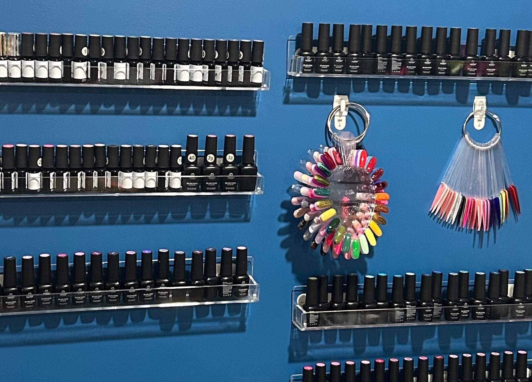 Nailss.ByKeira in Ottawa showcases a vibrant polish display with color samples.