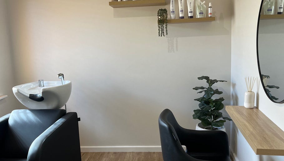 Elegant styling station at Sanctum Hair Studio, Mandurah, Western Australia, AU with mirror and greenery.