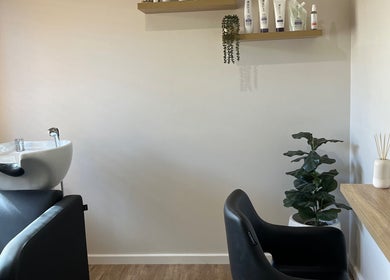 Elegant styling station at Sanctum Hair Studio, Mandurah, Western Australia, AU with mirror and greenery.