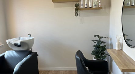 Elegant styling station at Sanctum Hair Studio, Mandurah, Western Australia, AU with mirror and greenery.