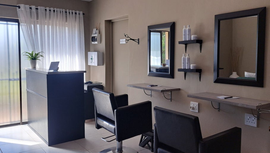 Modern salon interior at Scissors And Style in Pretoria, Gauteng, ZA showcasing stylish seating and decor.
