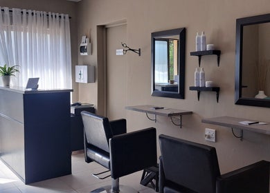 Modern salon interior at Scissors And Style in Pretoria, Gauteng, ZA showcasing stylish seating and decor.