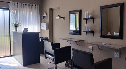 Modern salon interior at Scissors And Style in Pretoria, Gauteng, ZA showcasing stylish seating and decor.