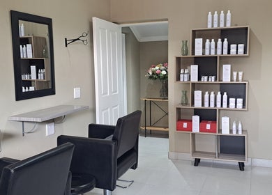 Chic salon interior at Scissors And Style, Pretoria, Gauteng, ZA showcasing product display and seating area.