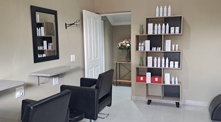 Chic salon interior at Scissors And Style, Pretoria, Gauteng, ZA showcasing product display and seating area.