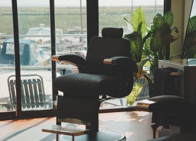 Comfortable barber chair at Wave Barber Studio, Southend-on-sea, England, GB, overlooking marina views.