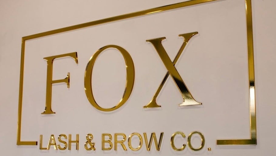 Signage of Fox Lash & Brow Co in Barry, Wales, GB, featuring elegant gold lettering.