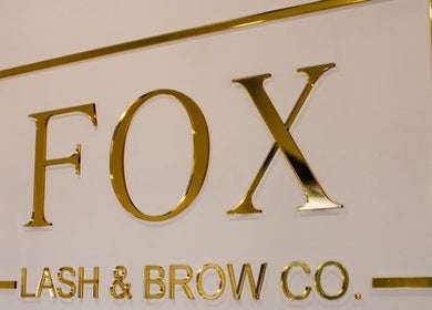 Signage of Fox Lash & Brow Co in Barry, Wales, GB, featuring elegant gold lettering.