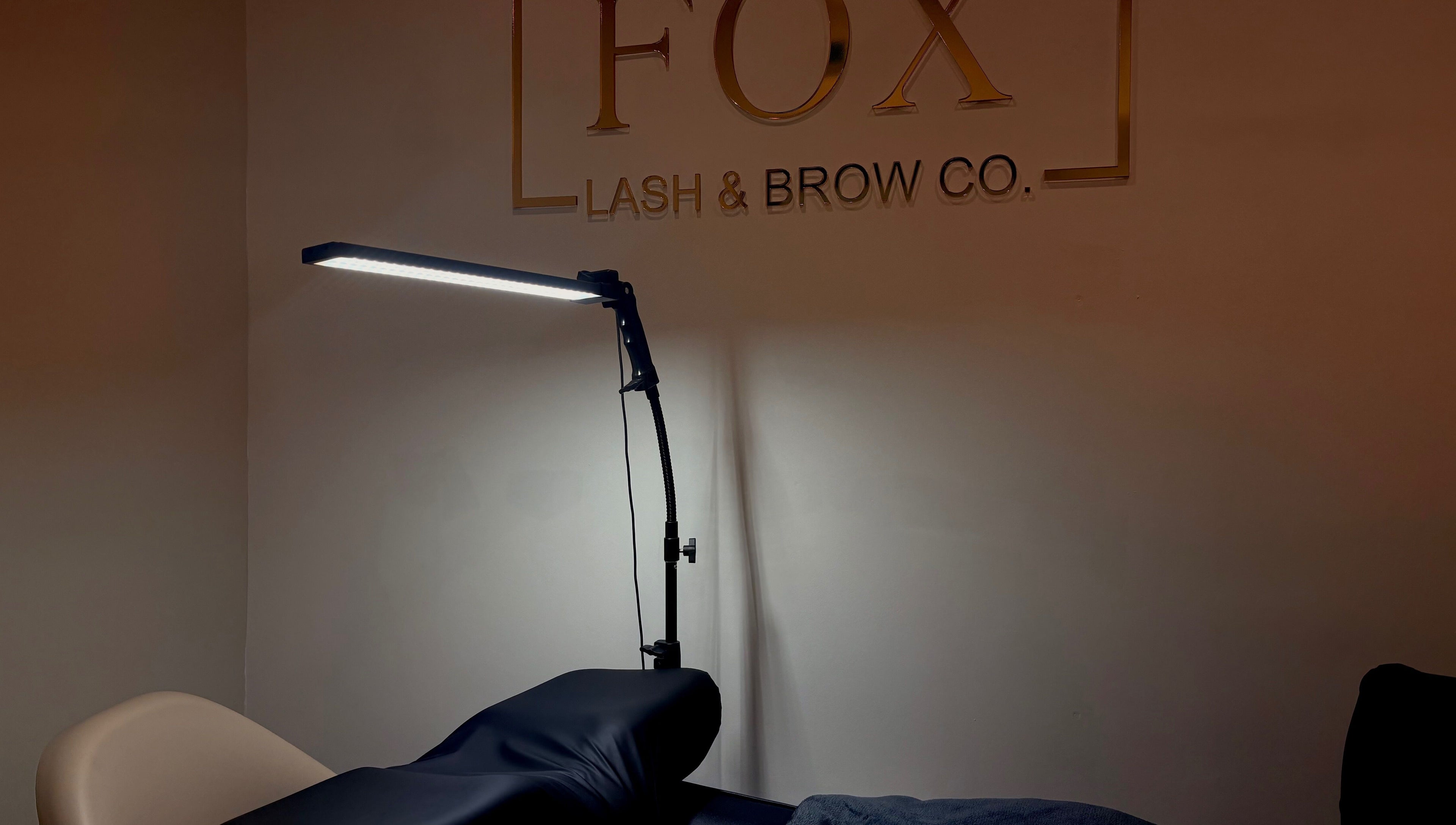 Relaxing treatment space at Fox Lash & Brow Co, Barry, Wales, GB, featuring a modern lamp.