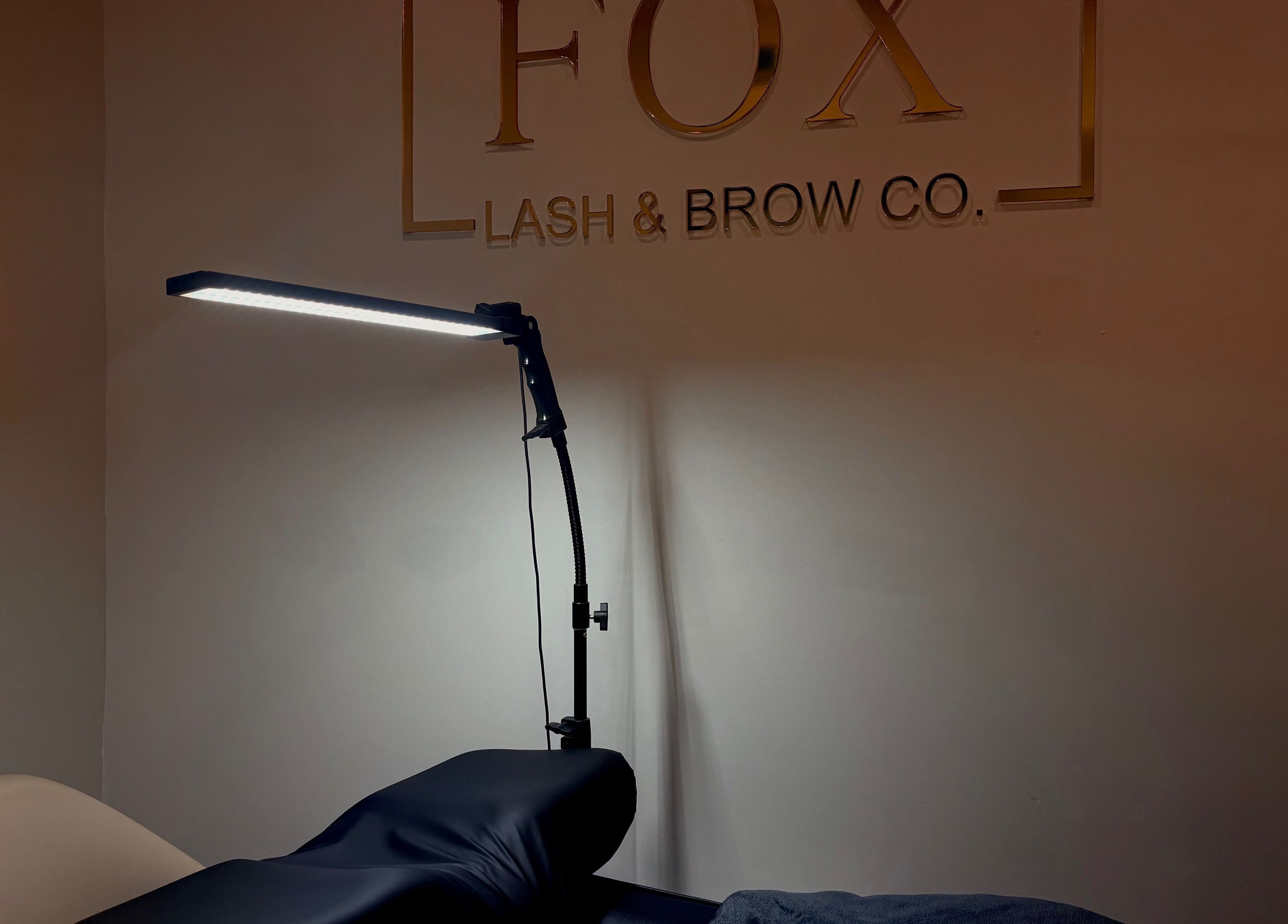 Relaxing treatment space at Fox Lash & Brow Co, Barry, Wales, GB, featuring a modern lamp.