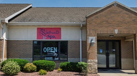 Front entrance of Mai Nail Salon & Spa in Appleton, Wisconsin, US, featuring open sign and greenery.