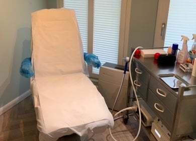 Comfortable treatment chair at Coventry Foot Clinic Whoberley, CV5 8BH, England, GB, with medical supplies nearby.