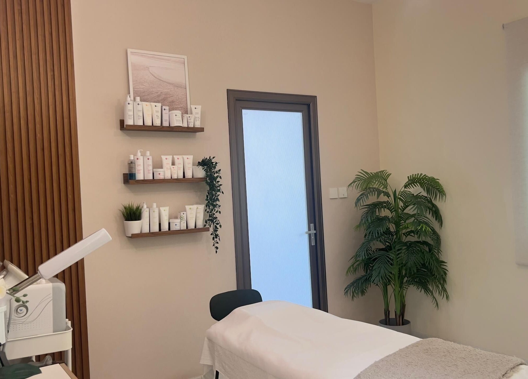 RAZ Salon treatment room in Muscat, Muscat Governorate, OM, featuring a serene massage bed and beauty products.