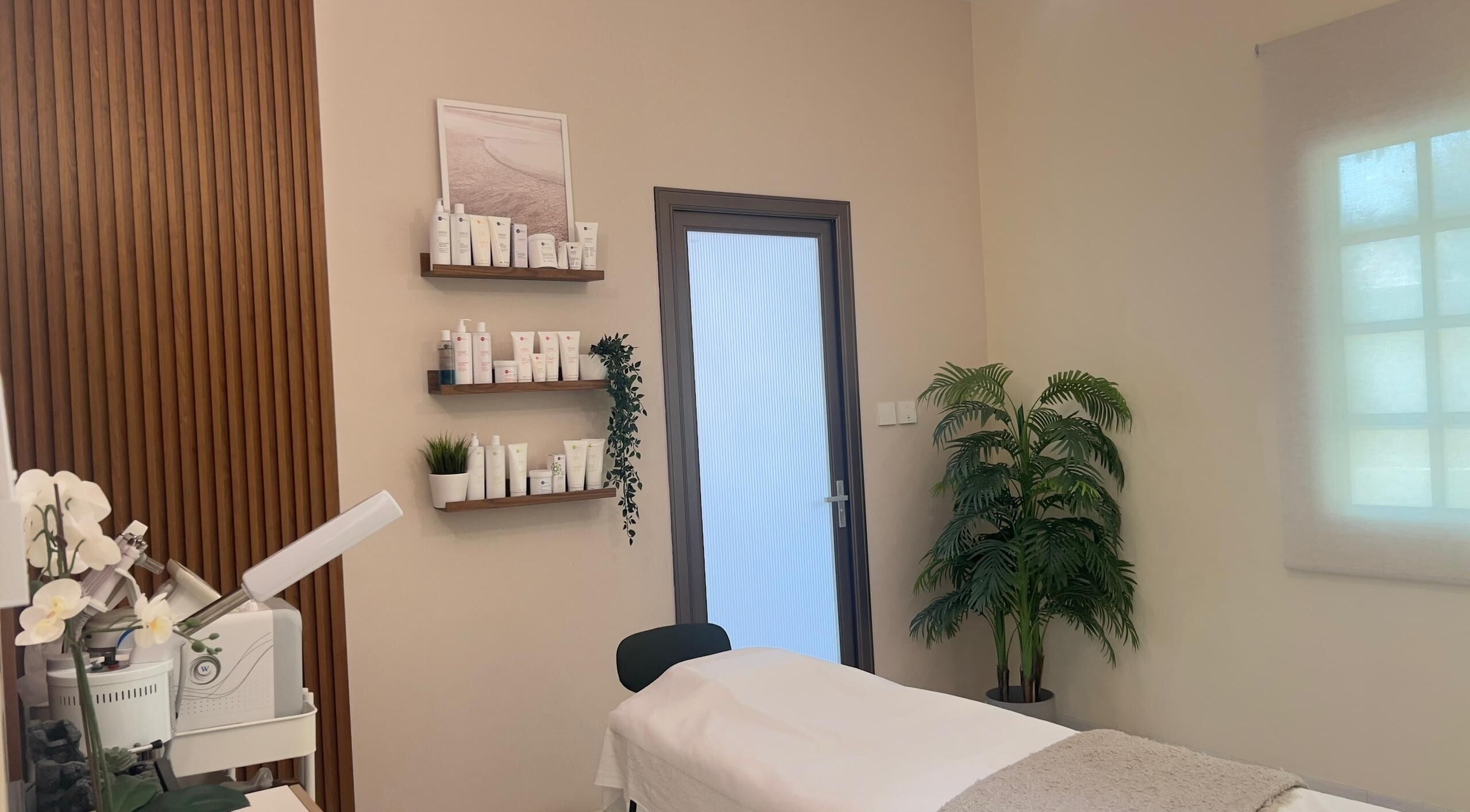 RAZ Salon treatment room in Muscat, Muscat Governorate, OM, featuring a serene massage bed and beauty products.