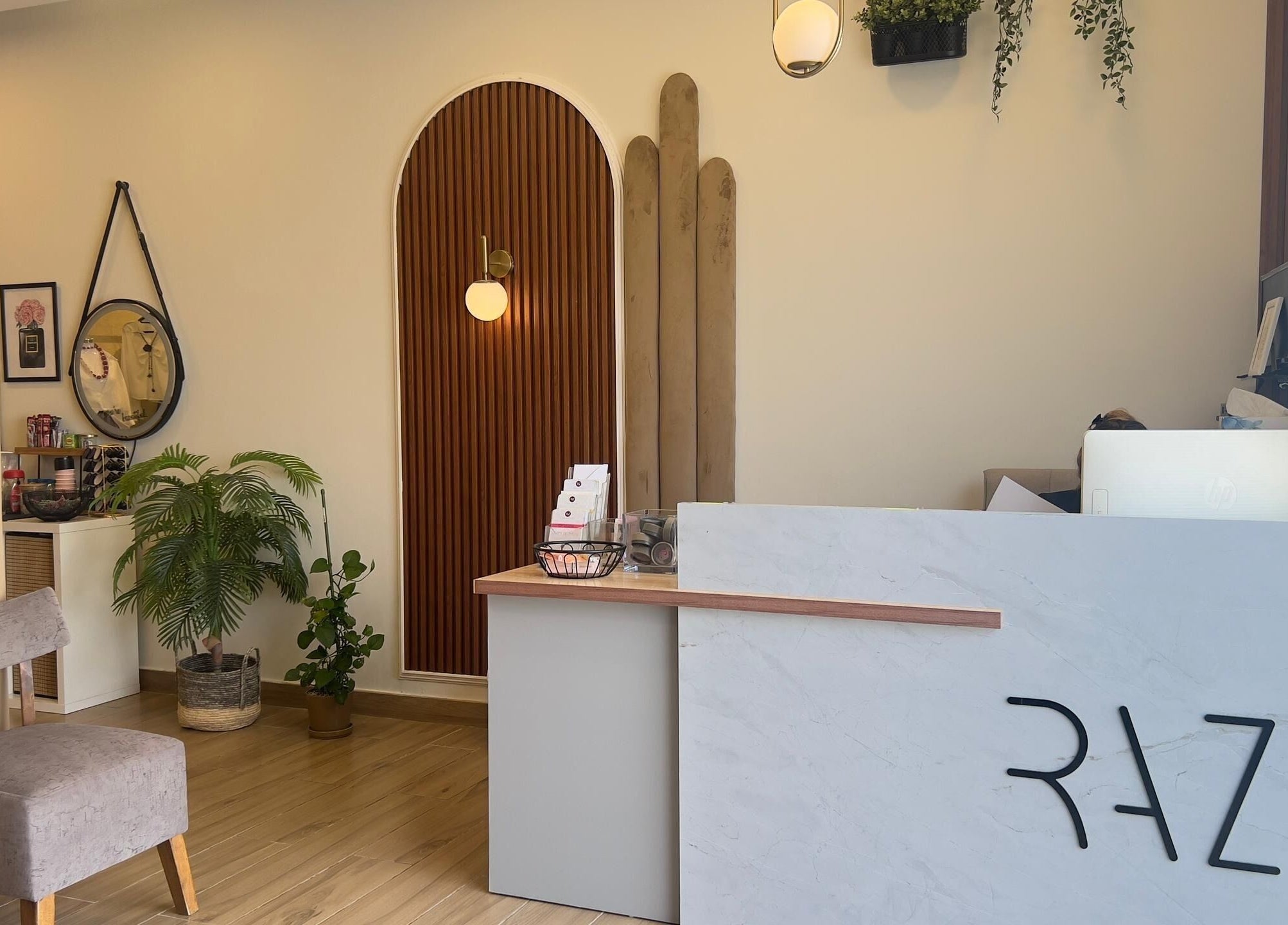 Stylish reception at RAZ Salon, Muscat, Muscat Governorate, OM with modern decor and soft lighting.