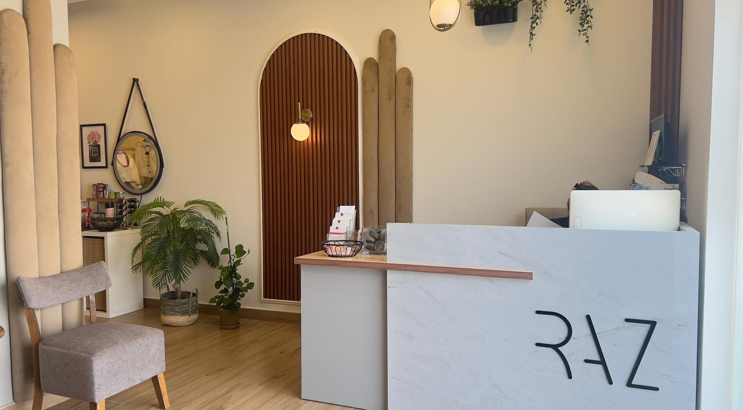 Stylish reception at RAZ Salon, Muscat, Muscat Governorate, OM with modern decor and soft lighting.