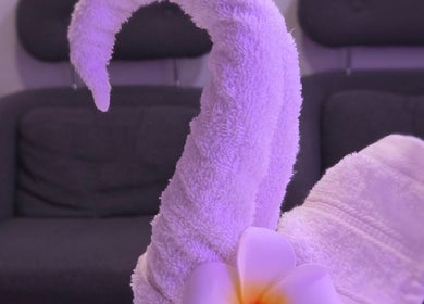 Artfully folded towel resembling a swan at KHUN MAI THAI MASSAGE in London, England, GB.