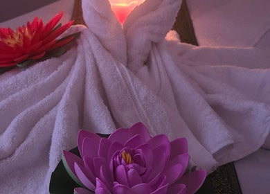 Elegantly folded towels with lotus flowers at KHUN MAI THAI MASSAGE, London, England, GB, creating a serene ambiance.