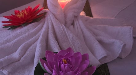 Elegantly folded towels with lotus flowers at KHUN MAI THAI MASSAGE, London, England, GB, creating a serene ambiance.