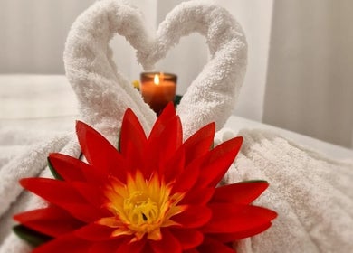 Elegant towel swans with a vibrant red flower at KHUN MAI THAI MASSAGE, London, England, GB.