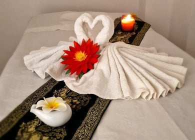 Elegant towel swan with red flower at KHUN MAI THAI MASSAGE, London, England, GB, enhancing relaxation ambiance.