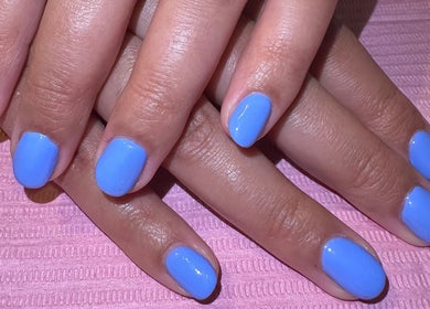 Close-up of manicured nails with blue polish at IC Nails in Aylesbury, England, GB.