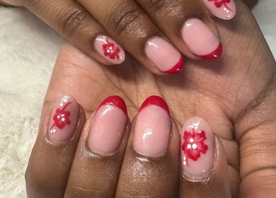Elegant nails with red floral design at IC Nails in Aylesbury, England, GB. Stylish and trendy manicure.