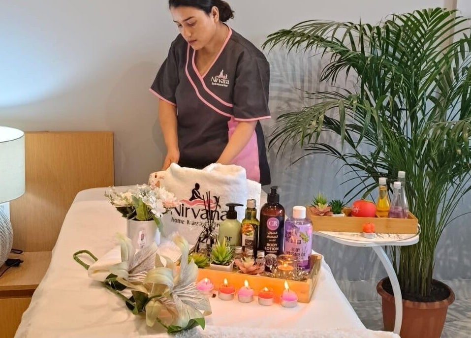 Massage therapist preparing relaxation area at Nirvana Home Spa Service, Dubai, Dubai, AE.