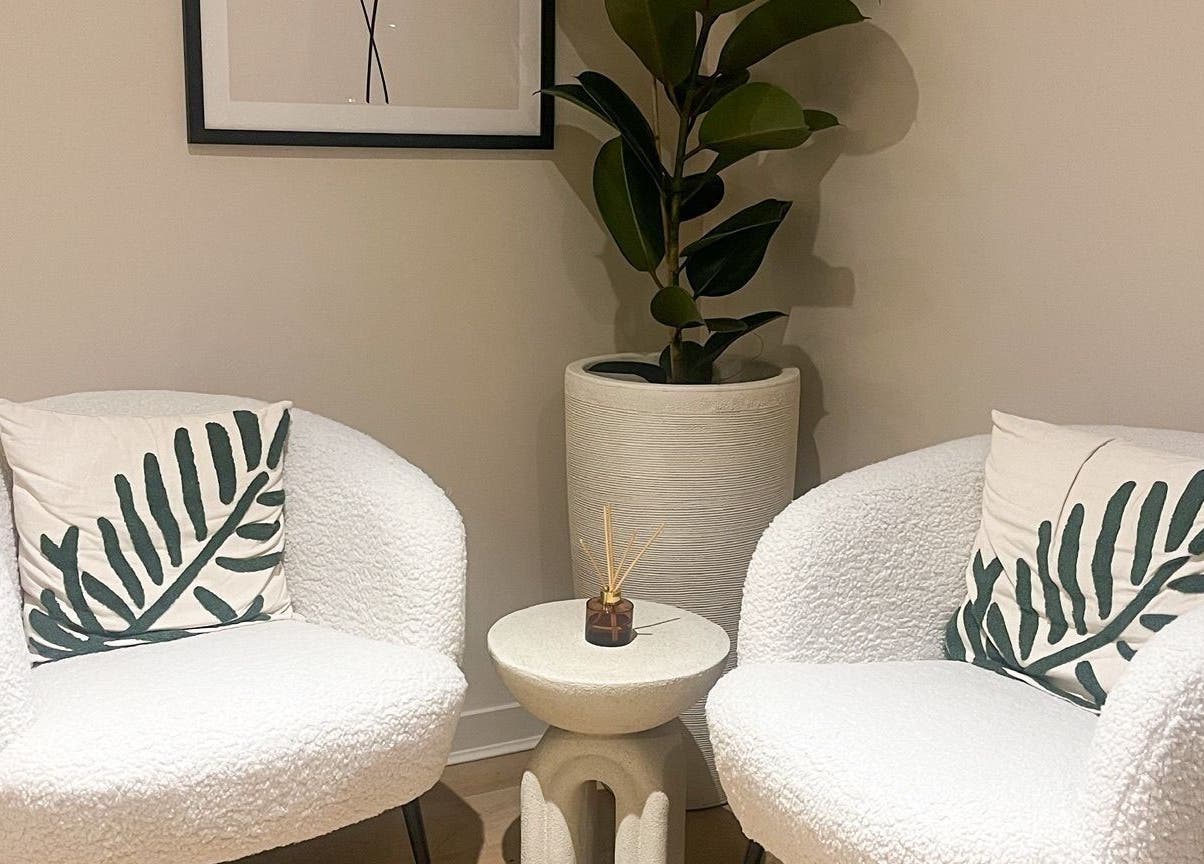 Stylish seating area at Candie Kings Aesthetics, London, England, GB with plush chairs and décor.