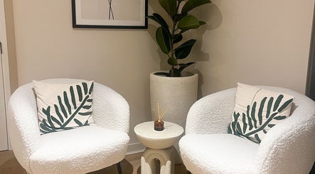 Stylish seating area at Candie Kings Aesthetics, London, England, GB with plush chairs and décor.