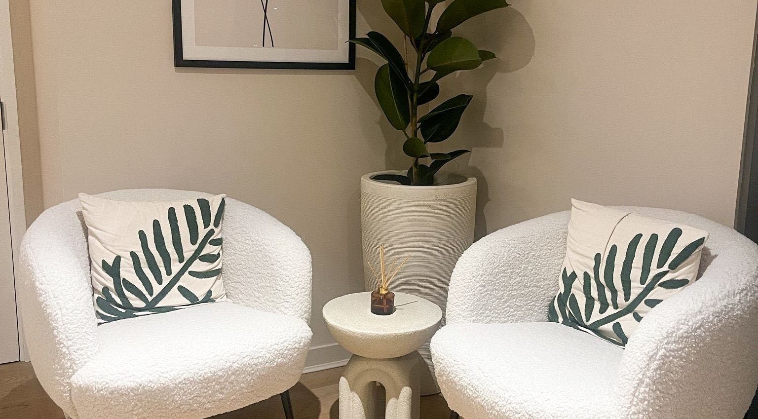 Stylish seating area at Candie Kings Aesthetics, London, England, GB with plush chairs and décor.