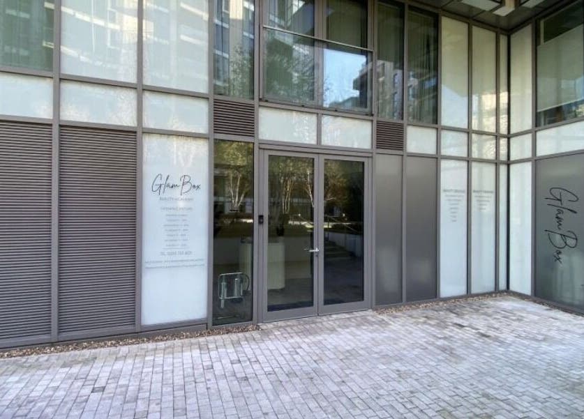 Front entrance of Candie Kings Aesthetics in London, England, GB, highlighting sleek glass design.