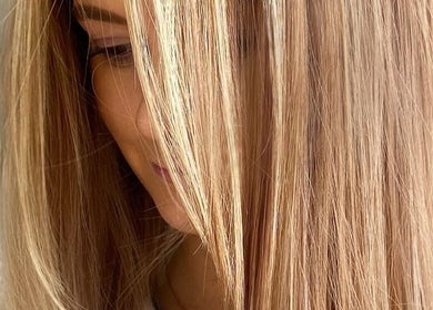 Smooth, golden blonde hair styled at Hair Anthem, Flagstone, Queensland, AU, showcasing vibrant color and shine.