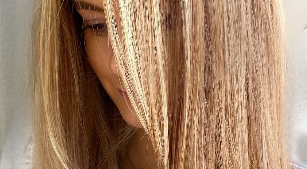 Smooth, golden blonde hair styled at Hair Anthem, Flagstone, Queensland, AU, showcasing vibrant color and shine.